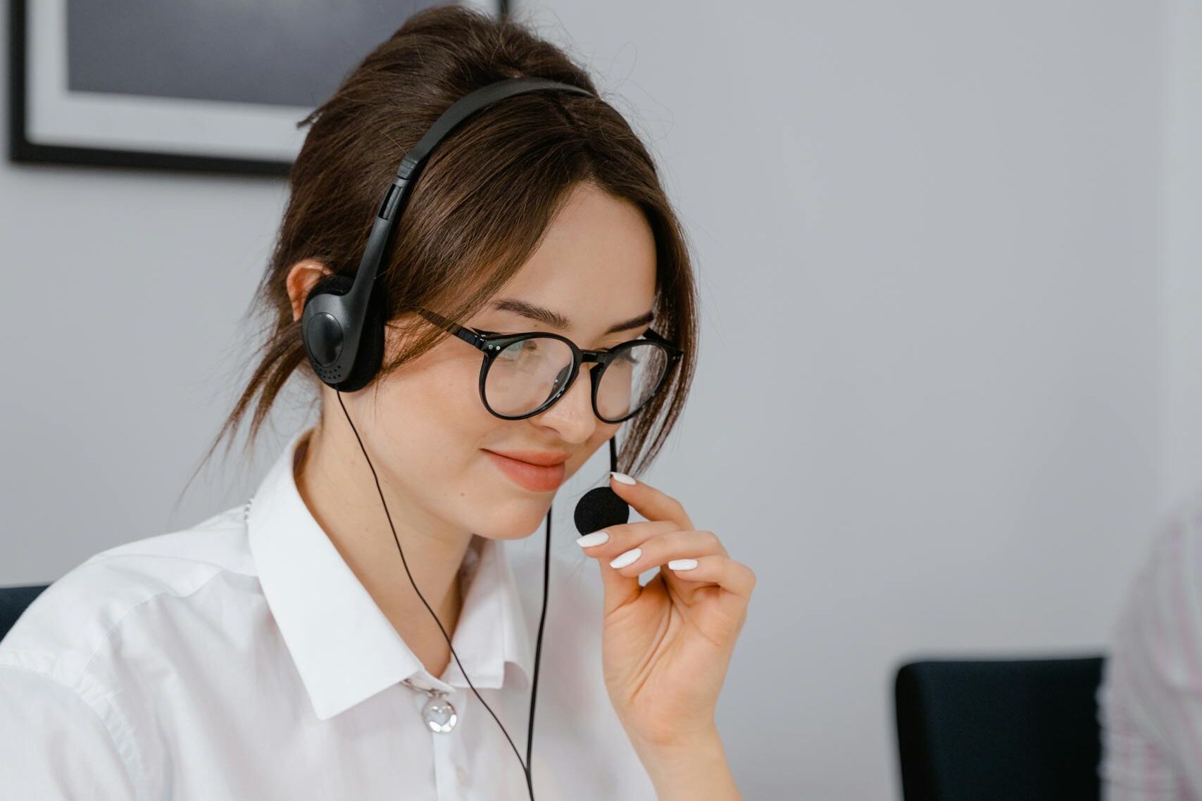 Professional woman using headset for customer service in office setting.